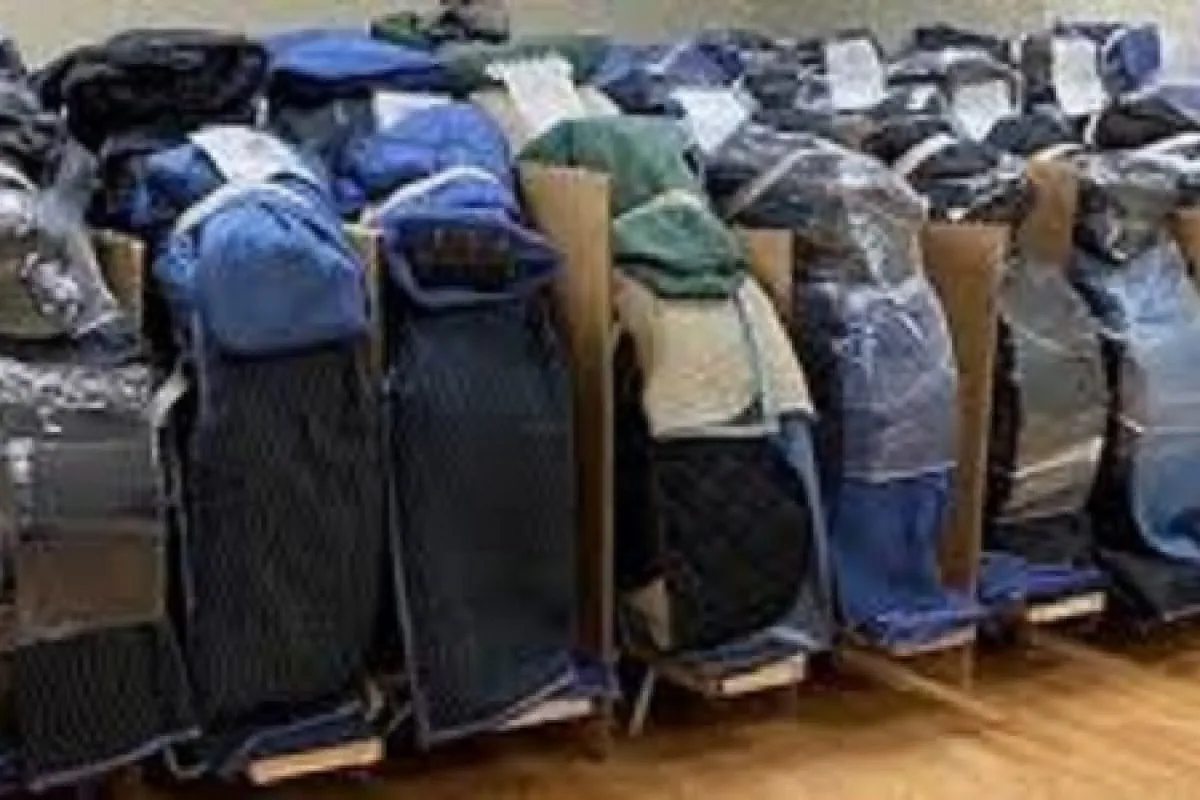 Blanket-wrapped pianos lined up in storage